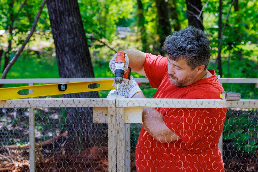 on a farm a worker uses a screwdriver to install 2023 11 27 05 35 10 utc